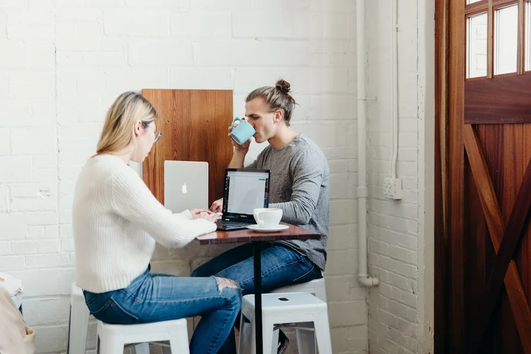 Sole trader comparing flat-rate and actual-cost expense calculations at a desk