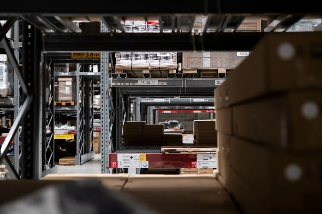 A UK ecommerce sole trader packing orders at a home desk, reviewing a business insurance policy