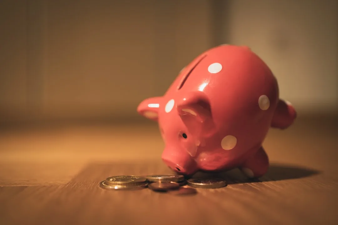 A UK saver reviewing bank statements at a kitchen table to check savings interest against the personal savings allowance
