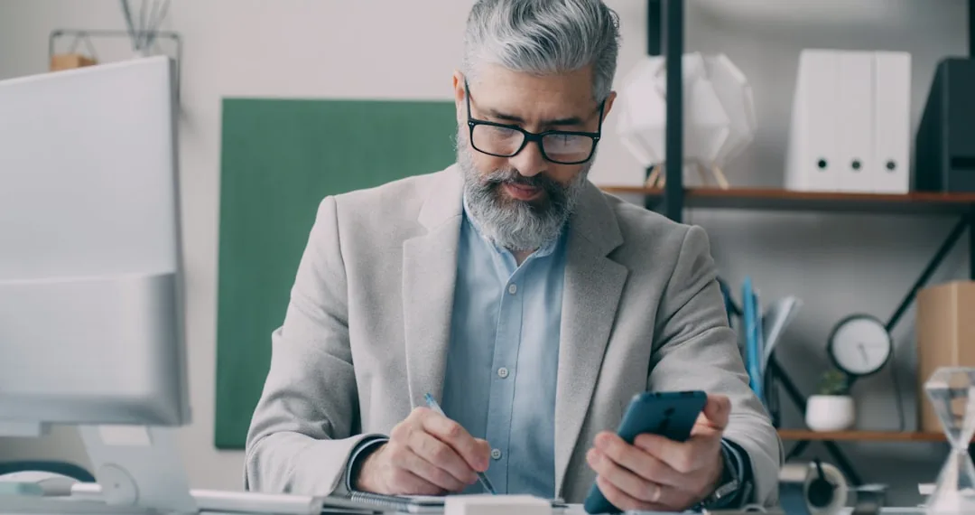 An ecommerce business owner reviewing VAT figures with an accountant at a desk