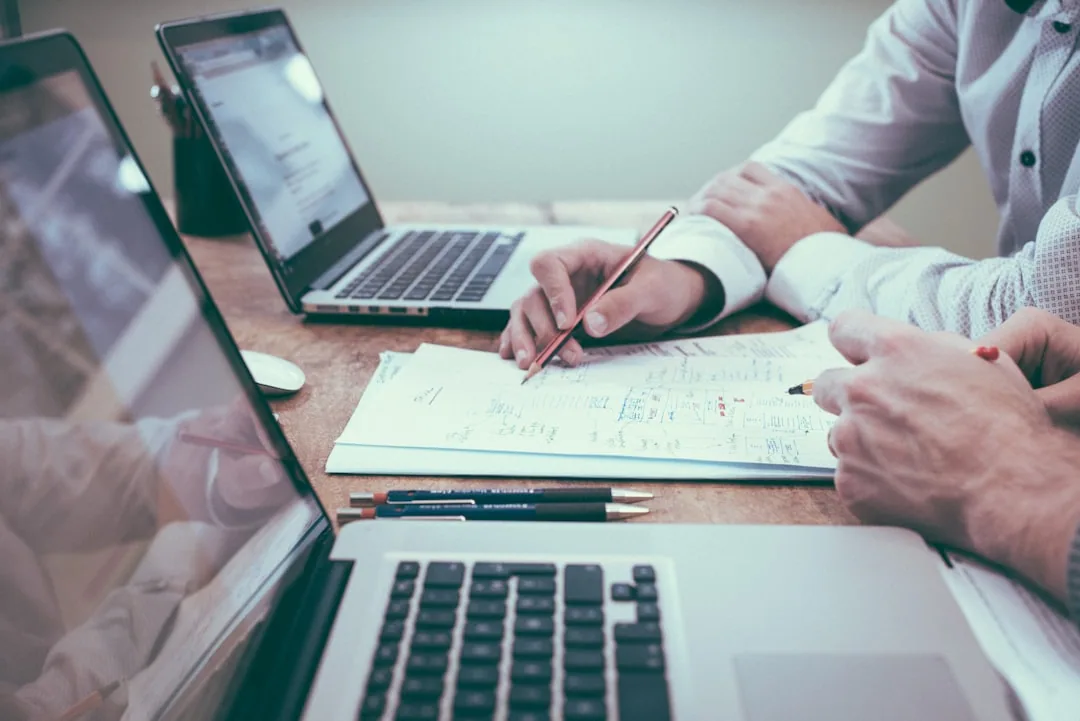 A UK company director reviewing a balance sheet to check retained profit at a desk