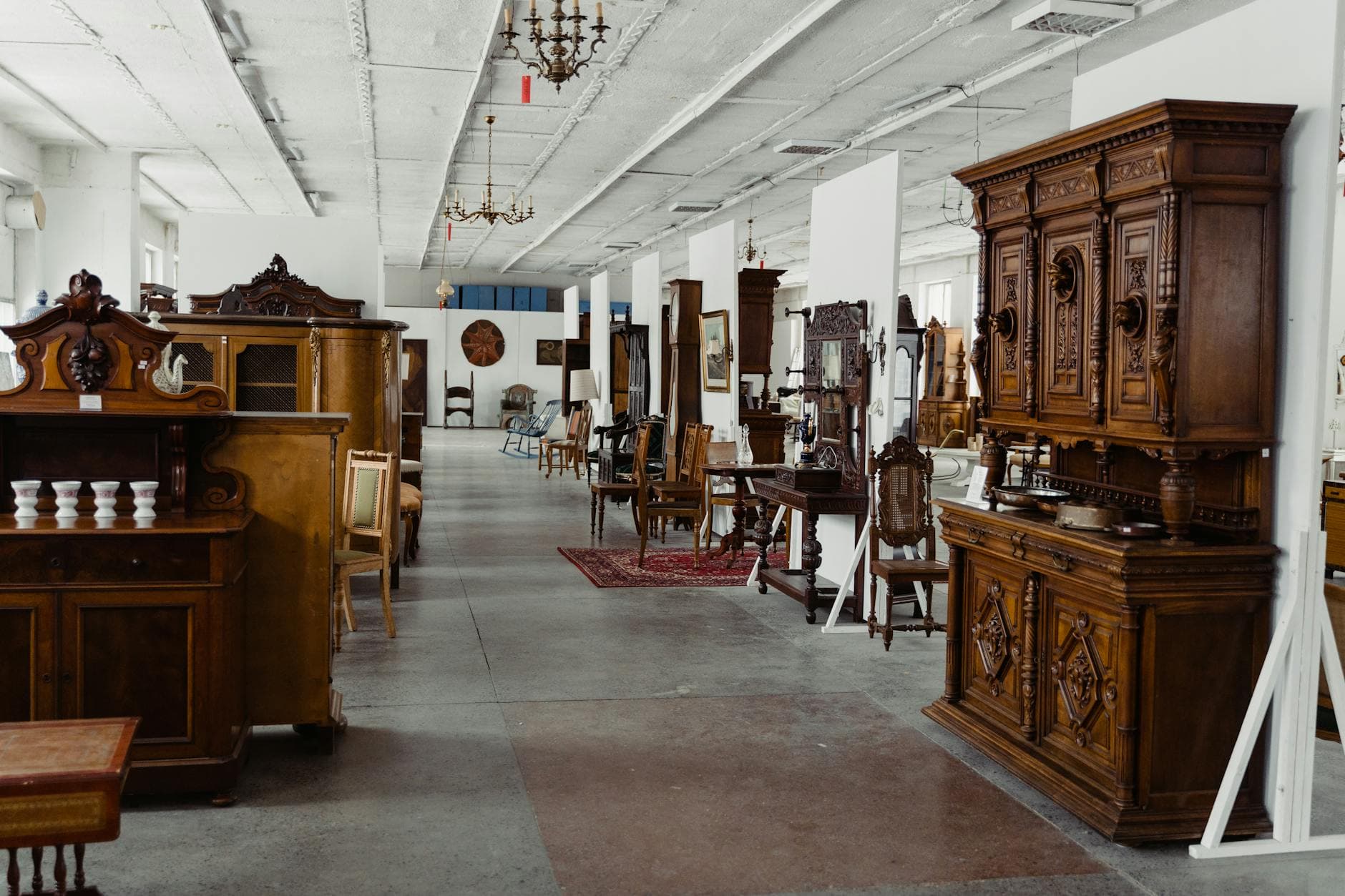 Antique furniture and collectibles displayed in a dealer showroom