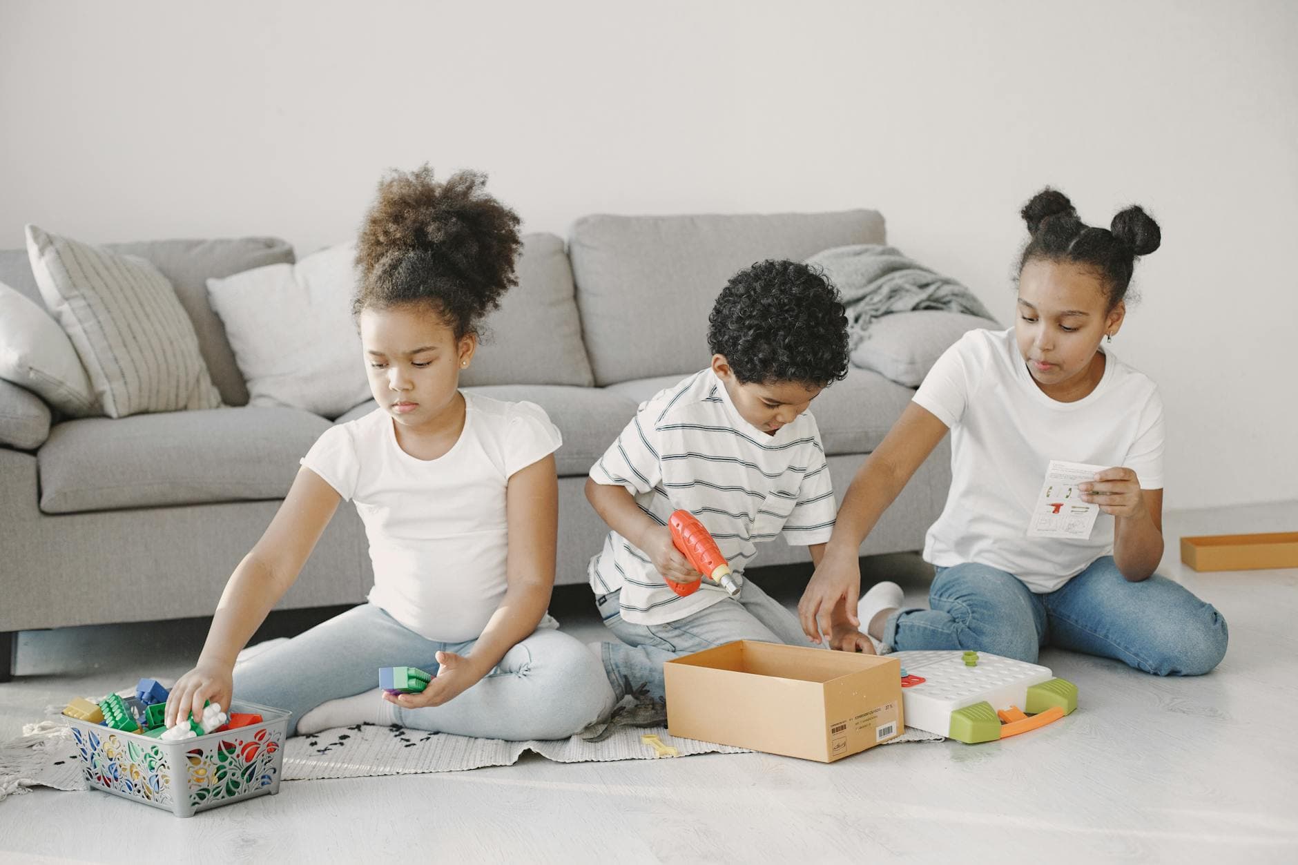 Childminder’s home with young children playing together with building blocks