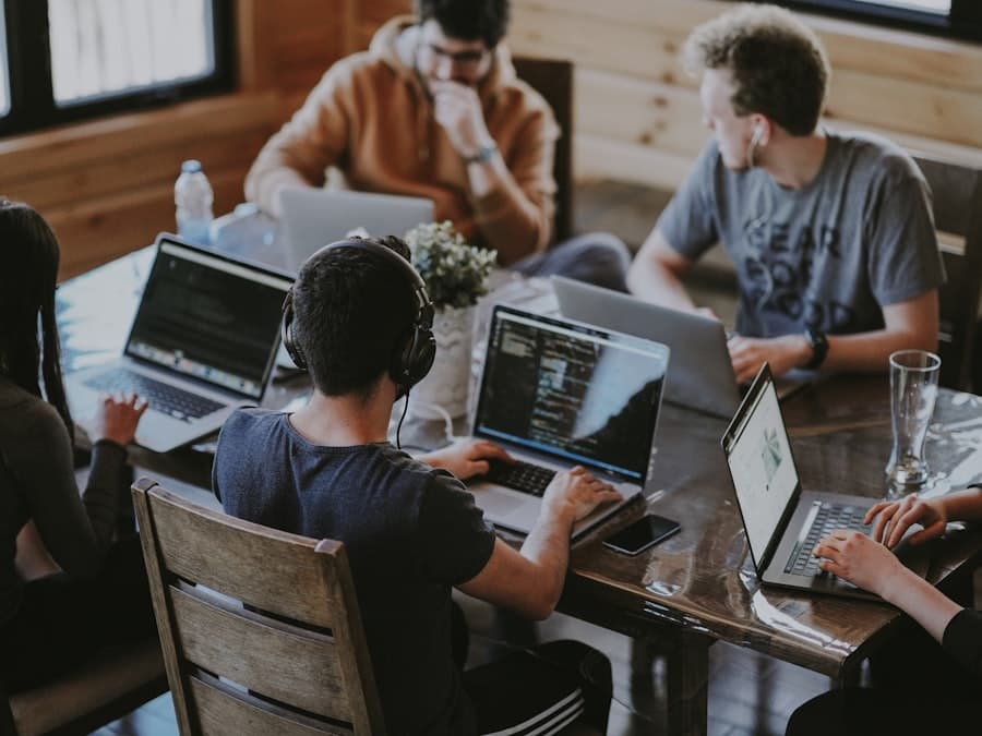 Team collaborating around a laptop in a bright office