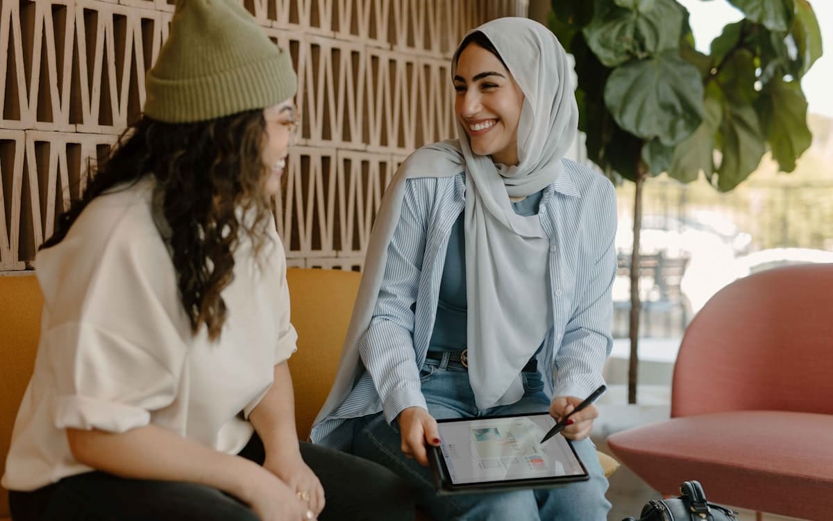 Startup founder and employee reviewing an EMI share option agreement on a laptop