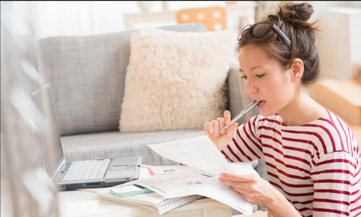 A Accountant reading and writing in a notebook.