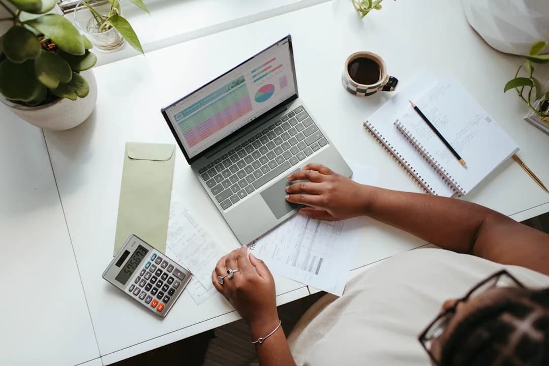 An ecommerce founder reviewing affiliate commission invoices from TikTok creators at a desk
