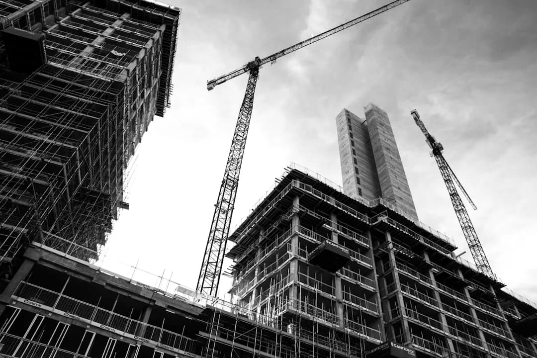 A construction contractor reviewing a payment certificate on site showing a retention amount withheld