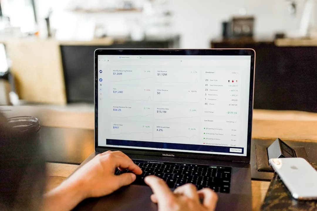 An Amazon seller reconciling a Seller Central settlement against a QuickBooks clearing account on a laptop