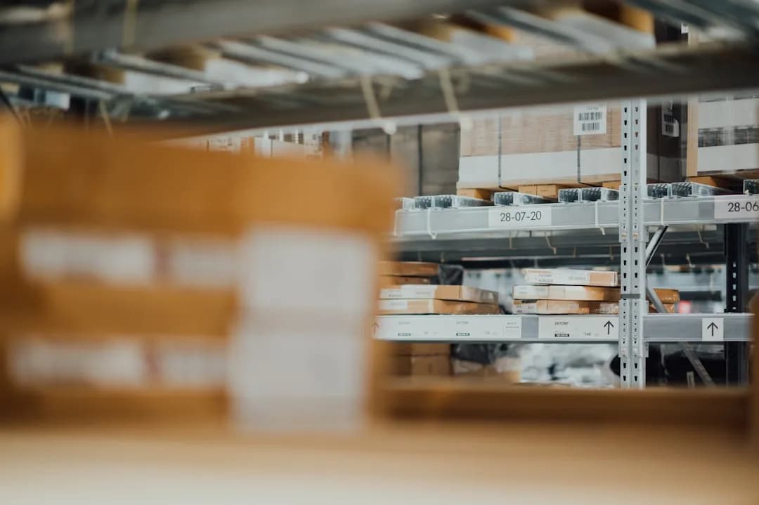 An Amazon FBA seller reconciling a settlement report against their bank payout at a desk