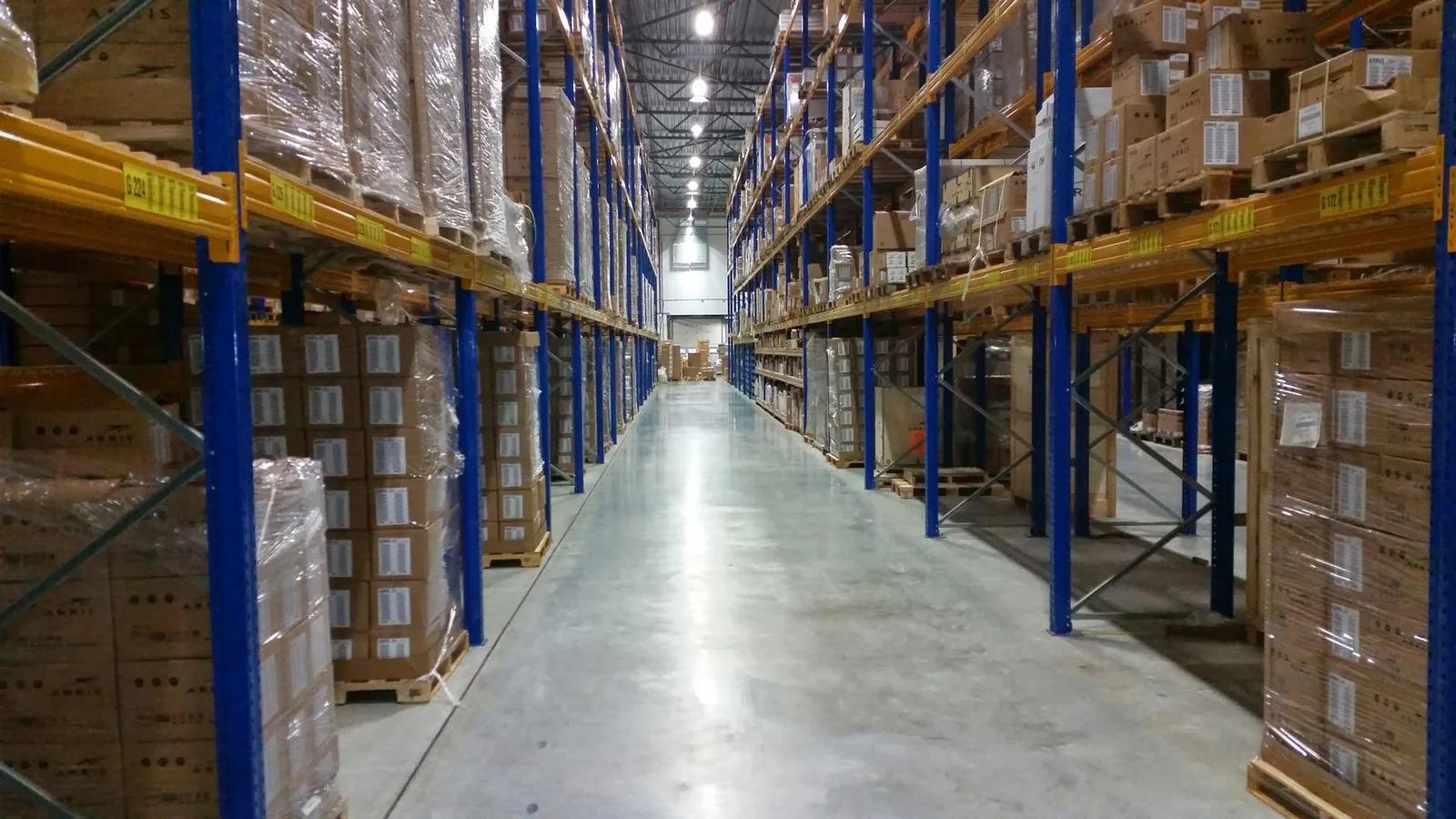 Amazon FBA warehouse shelves stacked with parcels during the UK holiday peak fulfilment period