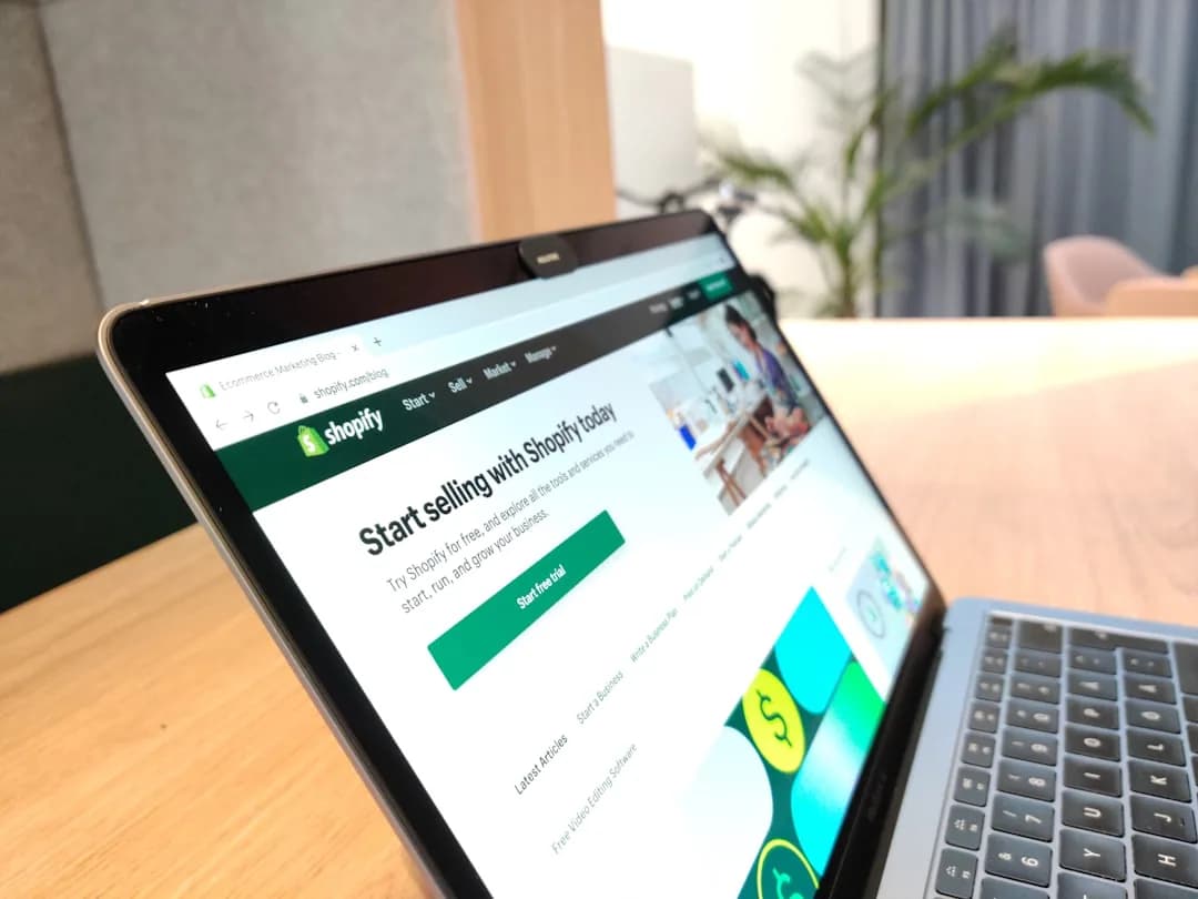 A UK Shopify seller reviewing their monthly subscription and app invoices on a laptop
