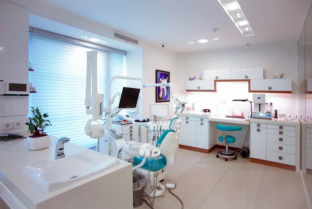 Associate dentist reviewing receipts and a laptop to total up allowable business expenses