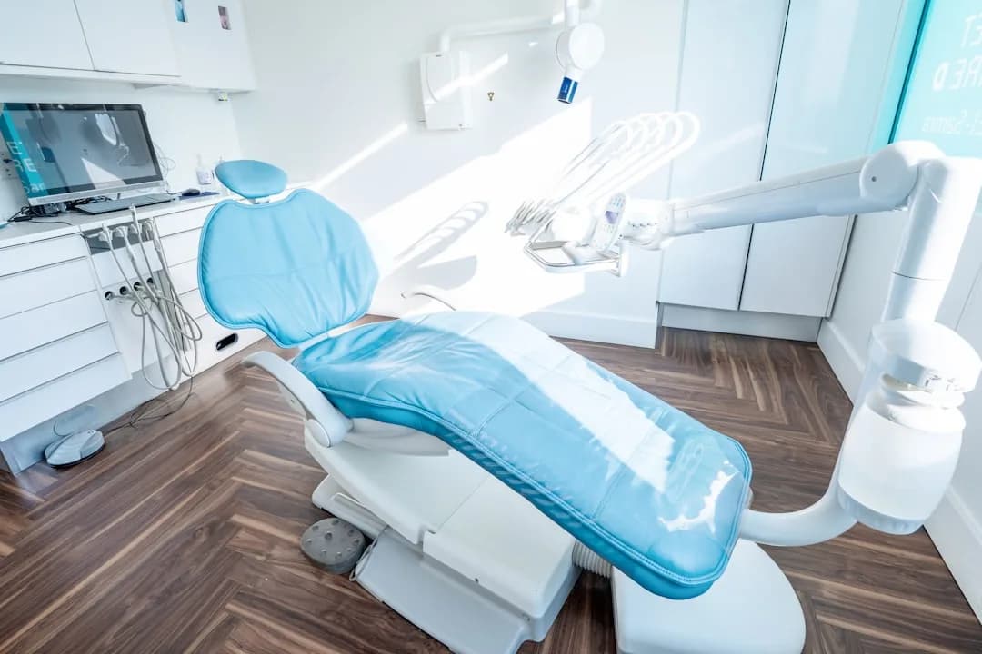 An associate dentist reviewing an associate agreement and tax papers at a practice reception desk