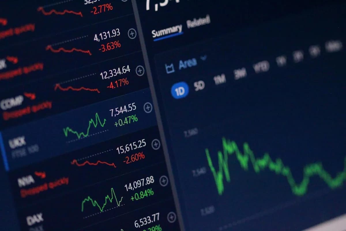 An investor at a desk reviewing a share portfolio statement to work out Capital Gains Tax