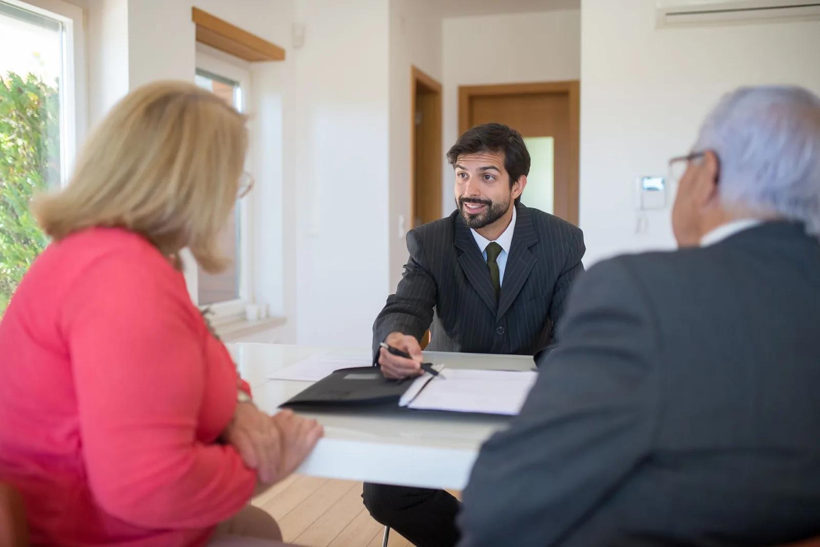 A UK accountant explaining capital gains tax rates and the annual allowance to a client at a desk