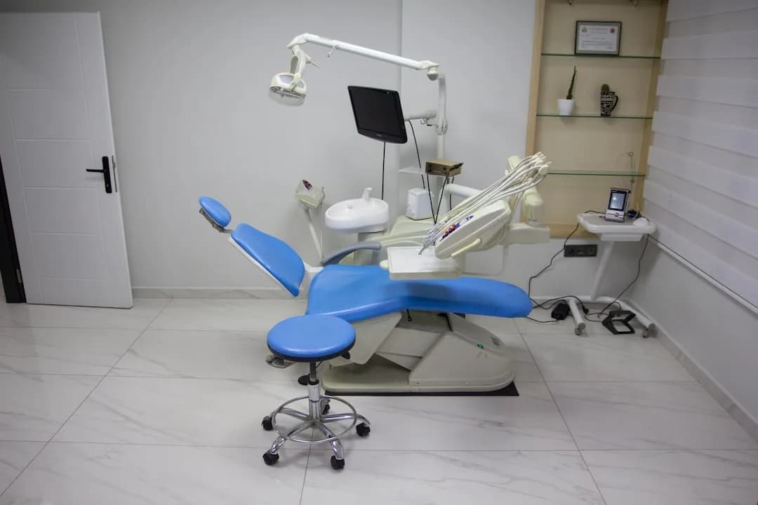 An associate dentist at a laptop running HMRC's CEST tool to check employment status for tax