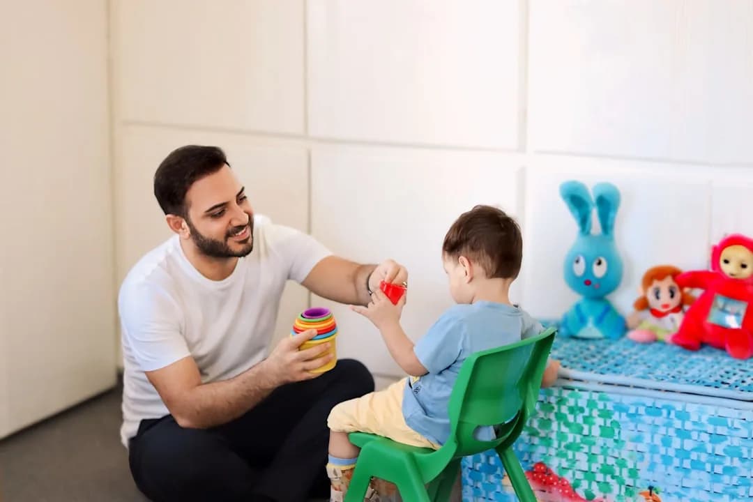 A new childminder setting up a playroom with toys and equipment while reviewing start-up receipts