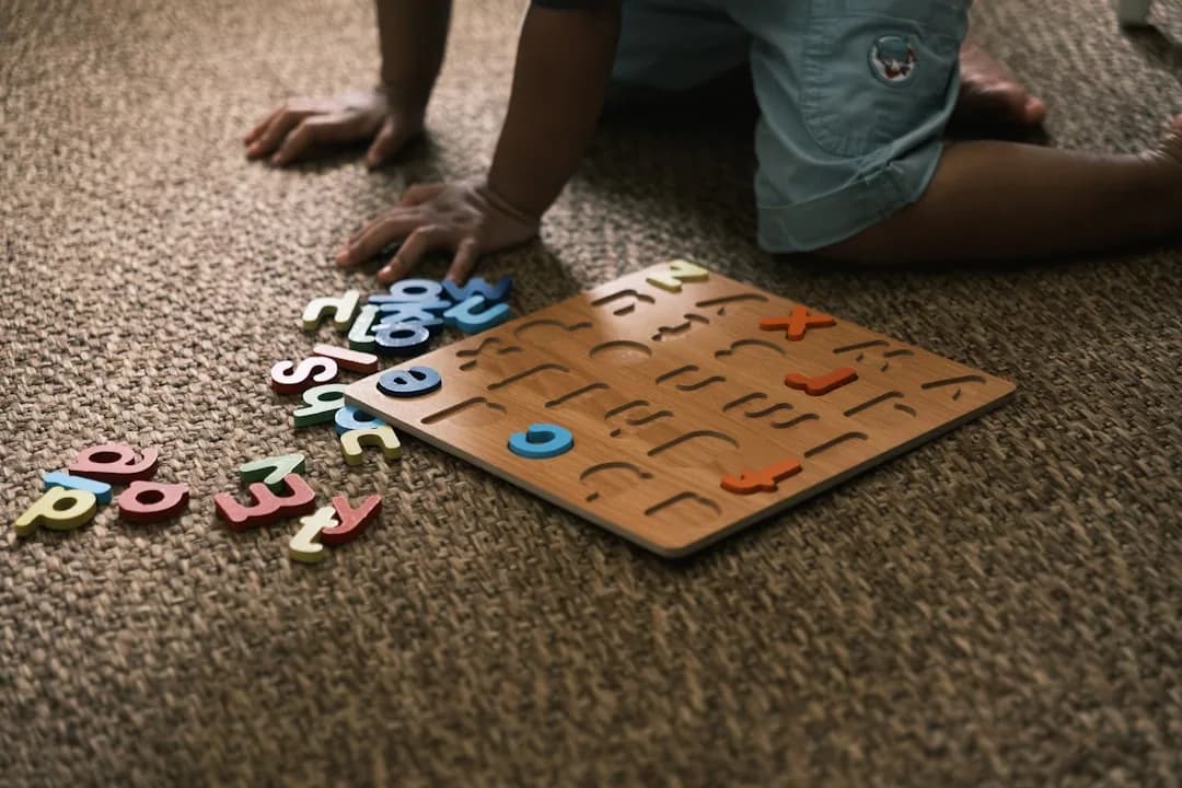 A childminder at a kitchen table comparing the trading allowance against real expenses with a calculator