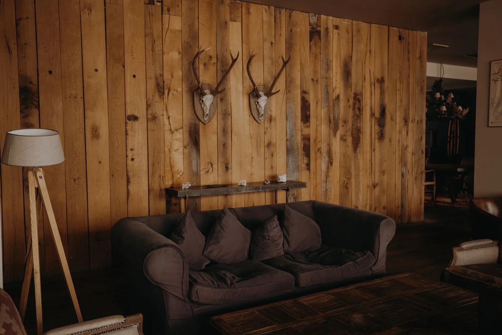 Warm, lived-in living room with rustic wall and cosy domestic furniture