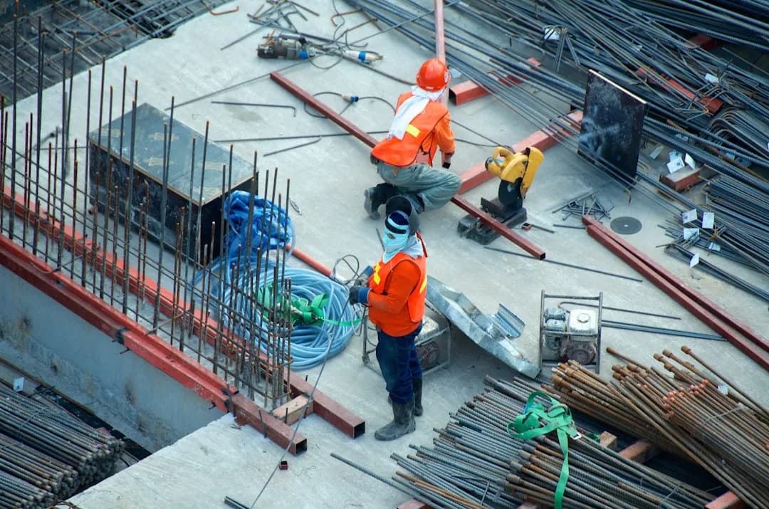 A construction subcontractor reviewing an invoice on site to split materials from labour for a CIS deduction