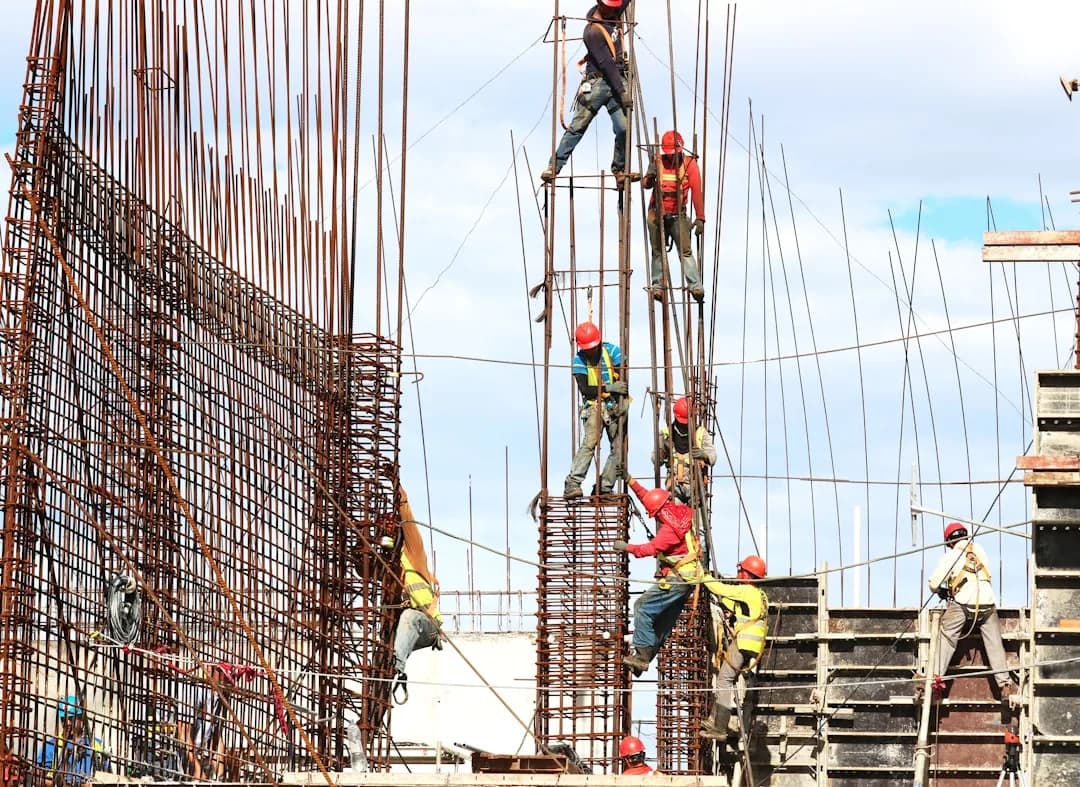 A UK builder reviewing an insurance certificate on a construction site before starting work