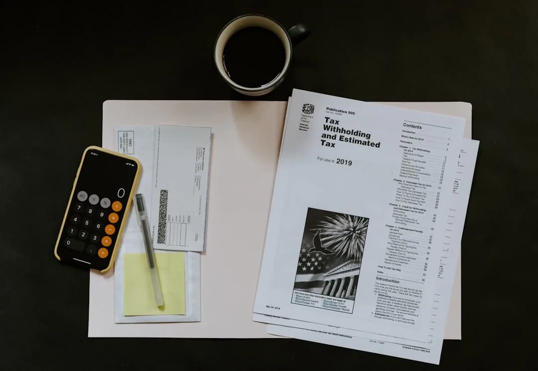 A limited company contractor at a desk sorting receipts and invoices to record allowable business expenses