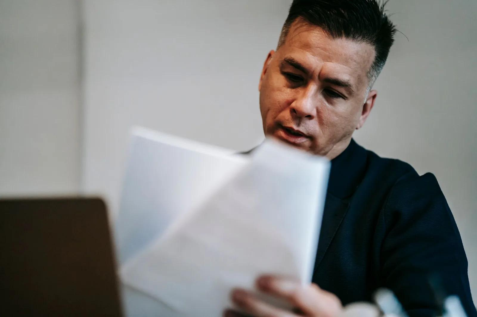 A limited company director reviewing a Corporation Tax penalty notice and CT600 paperwork at a desk