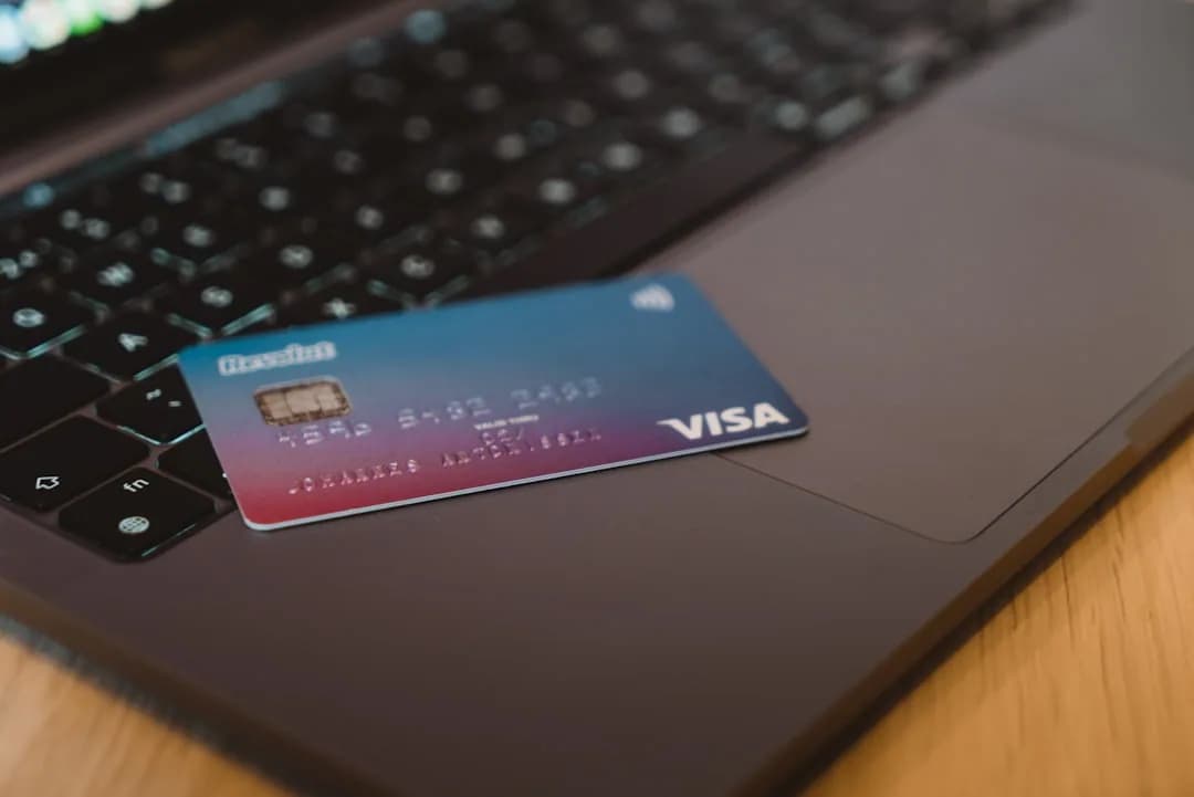 UK ecommerce seller checking business card spending on stock and ads at a desk