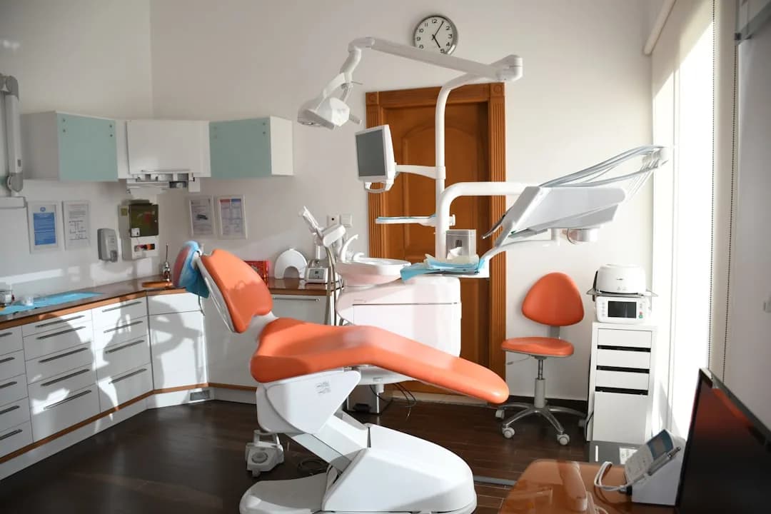 A dentist reviewing CPD course invoices and a laptop to check what training is tax deductible