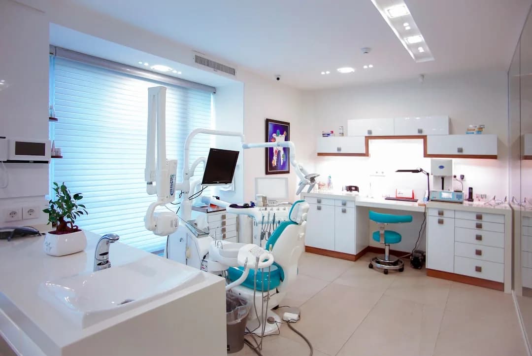 Dental practice owner reviewing year-end accounts and benchmarking figures at a surgery desk