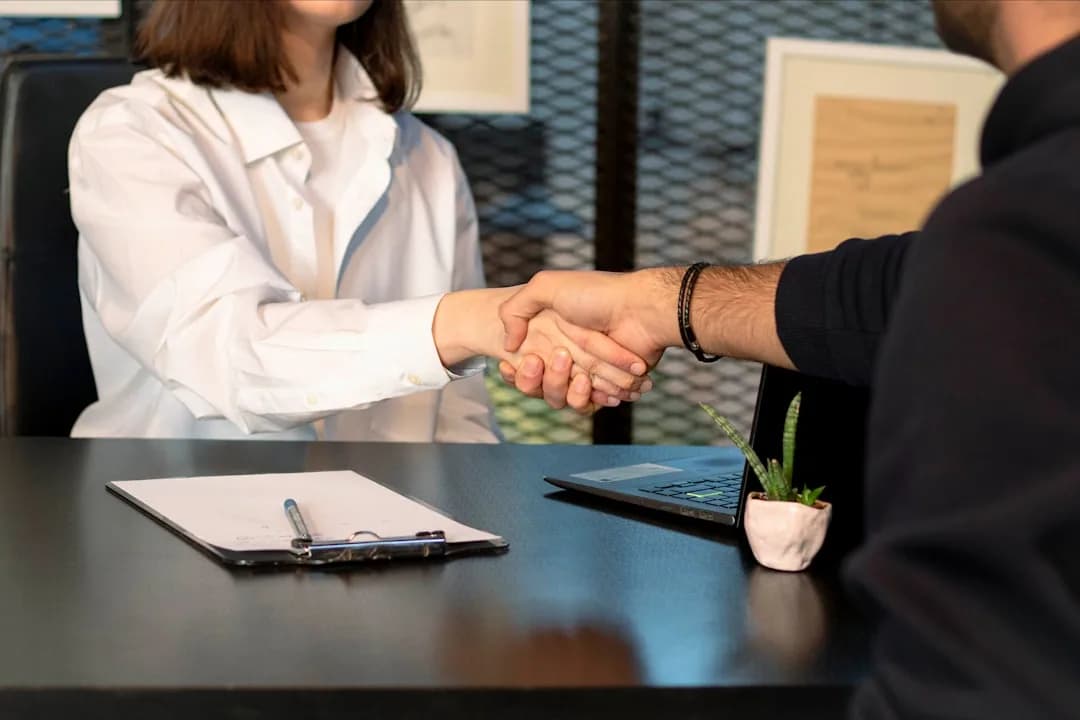 Startup founder and employee reviewing an EMI share option agreement on a laptop