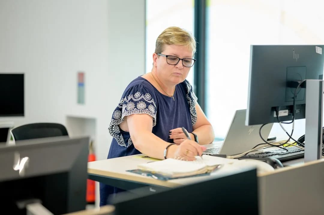 An accountant preparing a UK limited company's statutory accounts under FRS 102 at a desk with a laptop