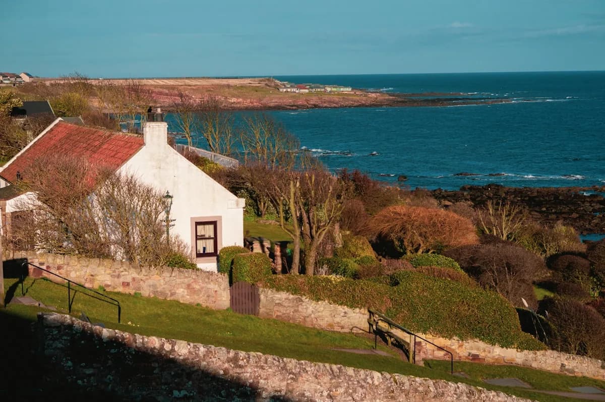 A holiday cottage owner reviewing rental expenses and receipts at a kitchen table