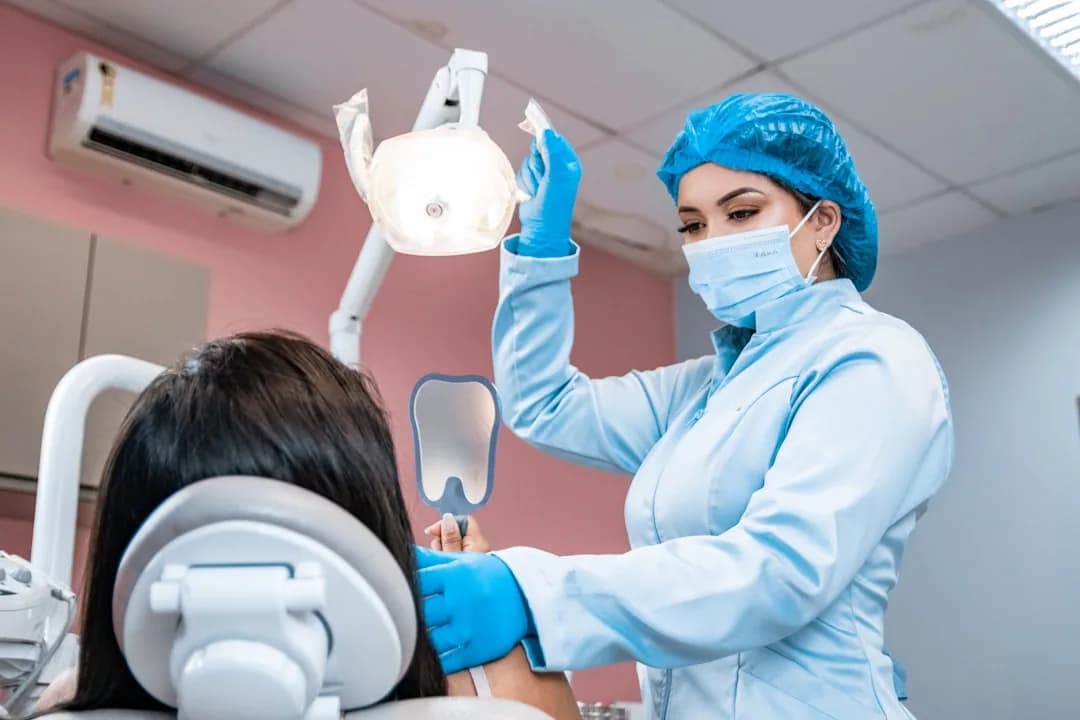 A UK dentist at a desk reviewing GDC registration and indemnity paperwork to check tax relief