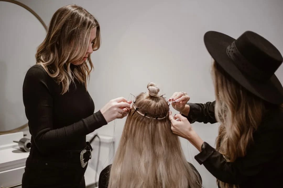 A hairdresser practising a new colouring technique on a mannequin head during a training course