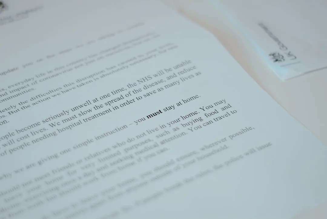 A UK business owner opening an HMRC compliance check letter at a desk with a laptop and paperwork