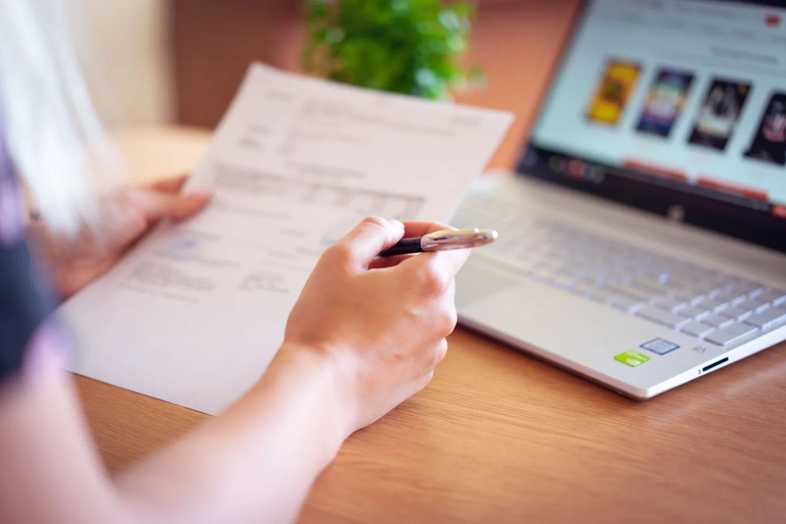 A UK landlord opening an official HMRC letter about Making Tax Digital for Income Tax sign-up