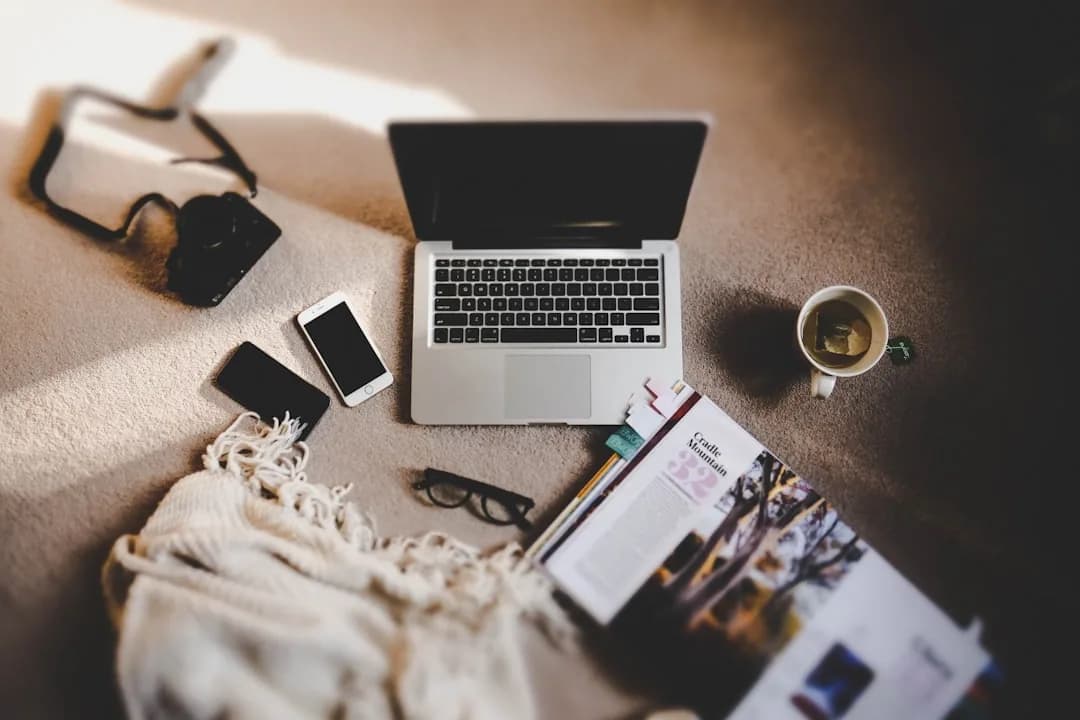 A UK accountant working from a home office desk reviewing client accounts on a laptop