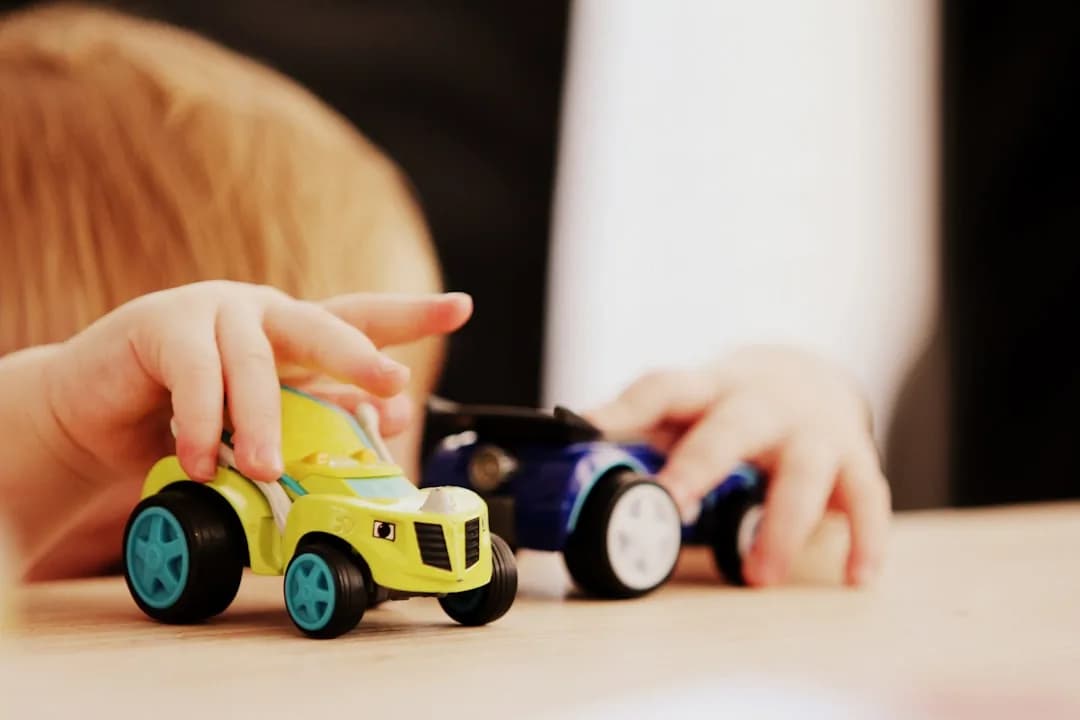 A childminder at a kitchen table registering as self-employed with HMRC on a laptop