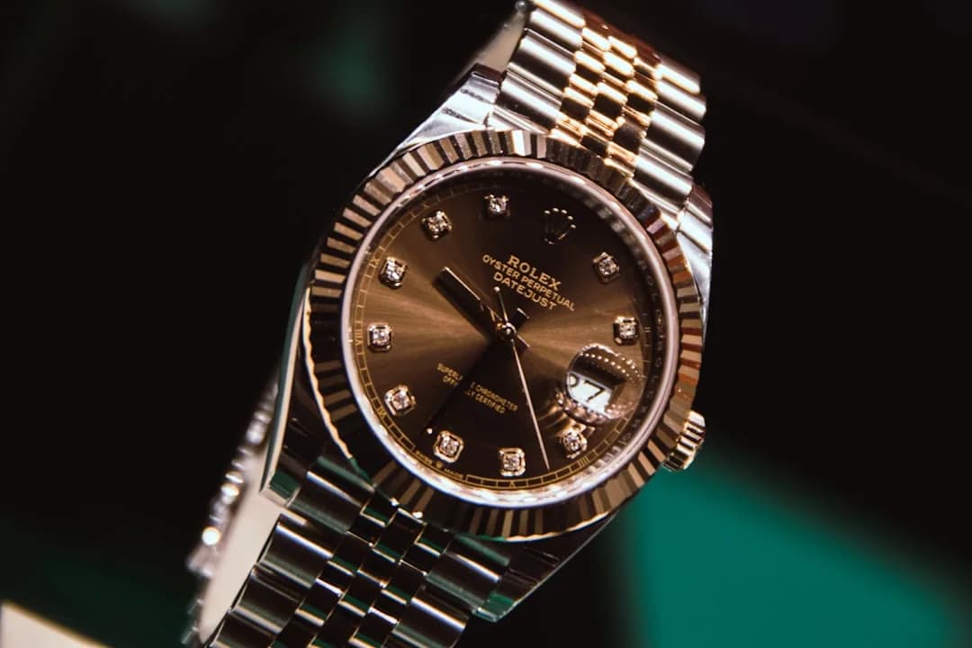 A watch dealer inspecting a pre-owned luxury watch at a workbench while reviewing import paperwork