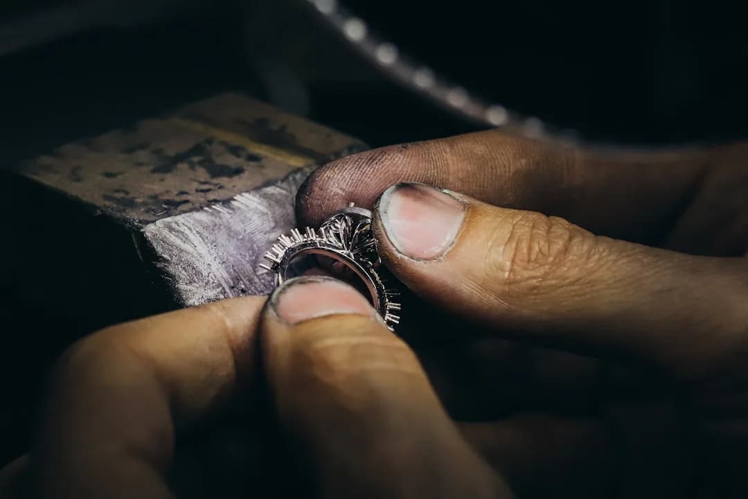 A jeweller weighing a gold ring at the counter while a customer pays, illustrating the cash payment rules