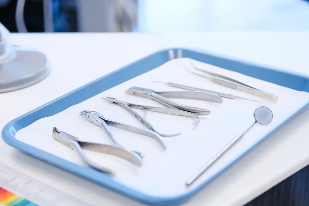 An associate dentist reviewing income records on a laptop in a UK dental surgery before MTD