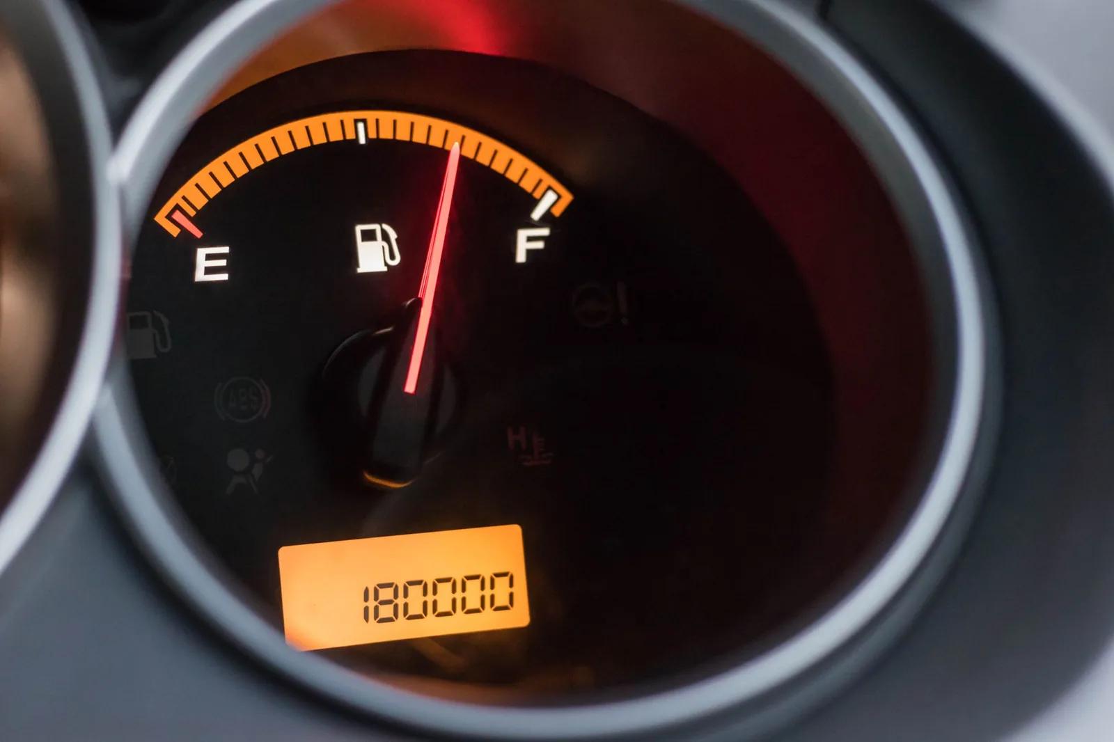 Close-up of a vehicle odometer and fuel gauge, illustrating business mileage a self-employed driver claims at the 55p flat rate