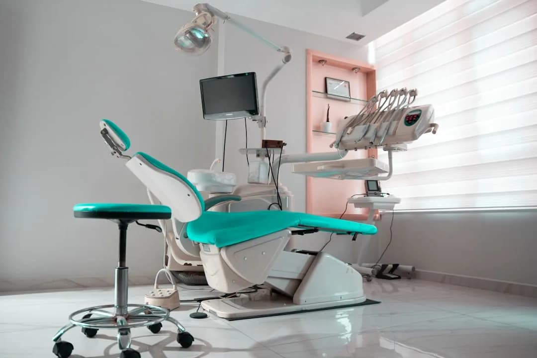 A dentist reviewing NHS and private income figures with an accountant at a practice desk