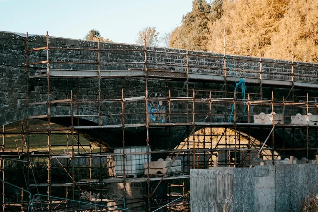 A construction contractor checking CIS monthly return deadlines on a laptop on site