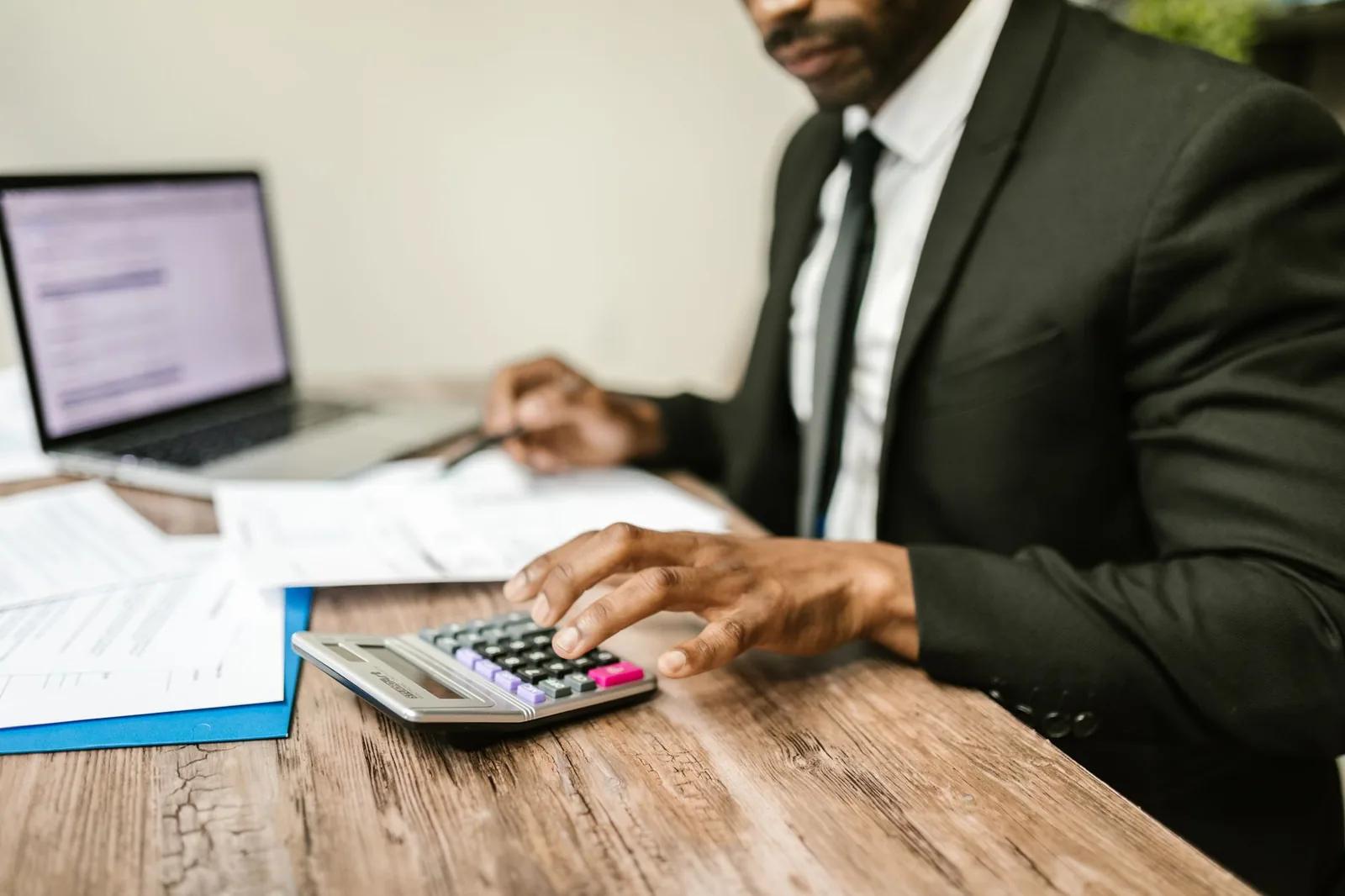 UK payroll manager reviewing company car and medical benefit figures on a laptop ahead of the 2027 mandatory payrolling change