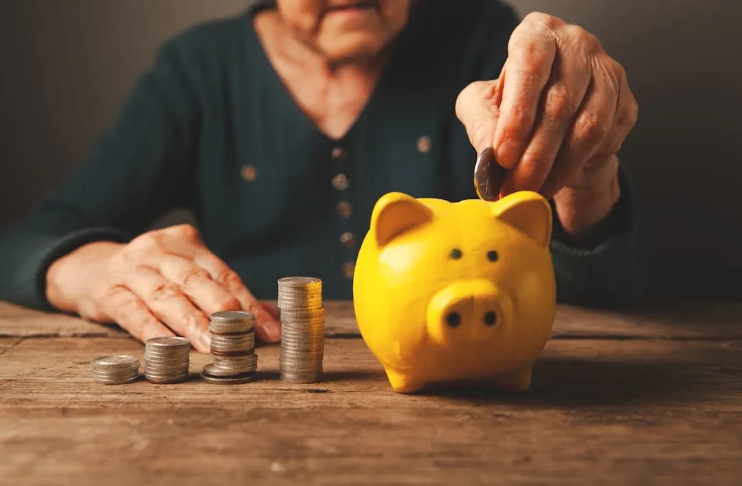 UK business owner reviewing pension statement and payslip at a desk to check tax relief
