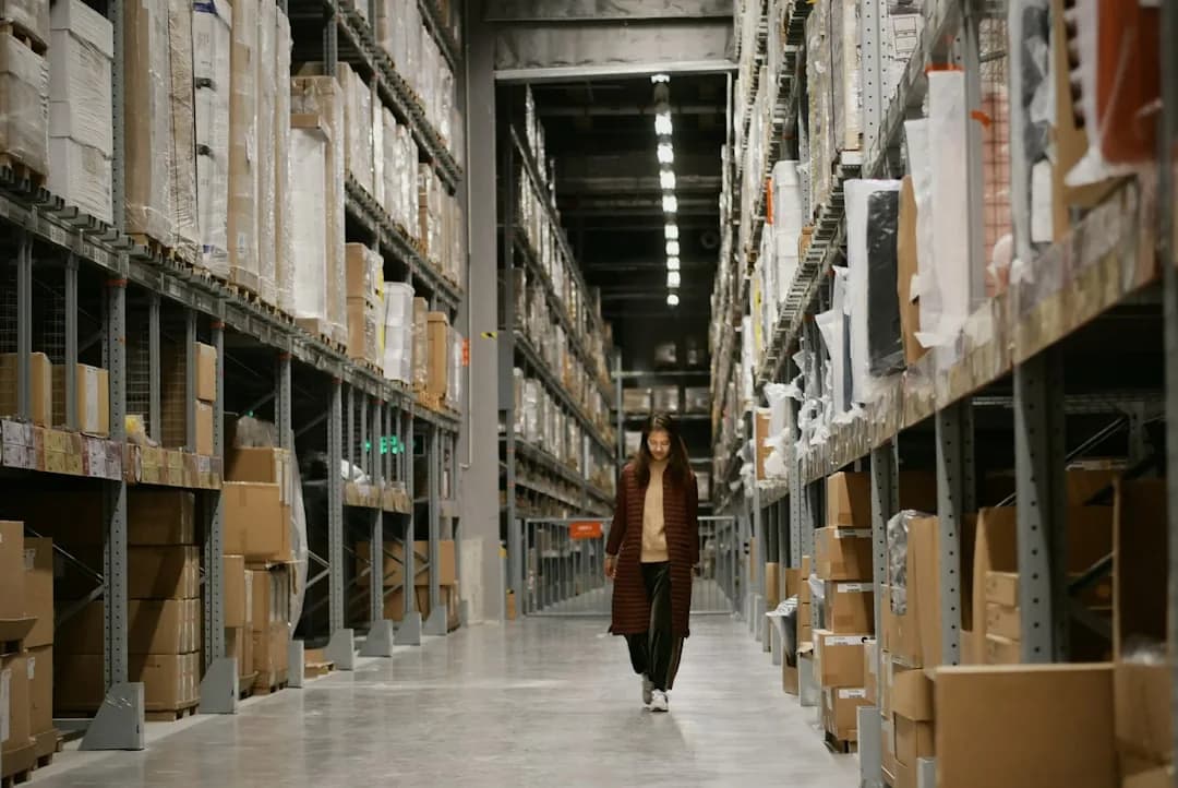 An Amazon FBA seller reviewing fee invoices on a laptop to reclaim VAT charged on seller fees