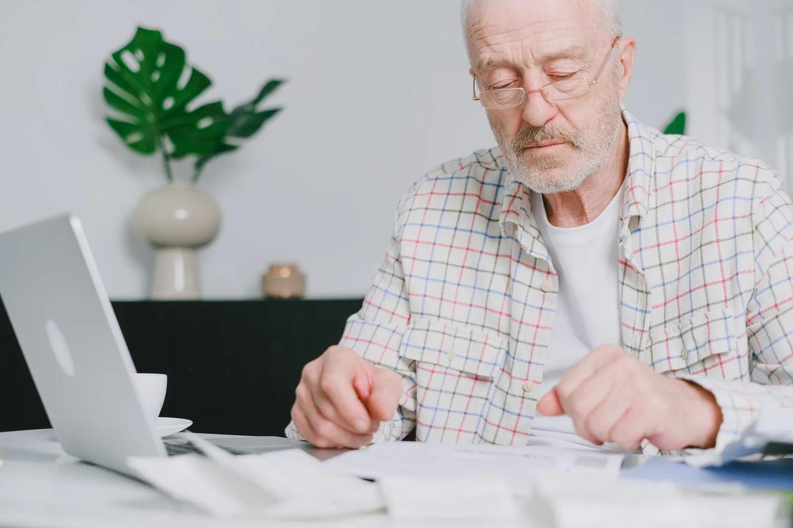 A UK taxpayer reviewing Self Assessment payment dates and a PAYE tax code on a laptop